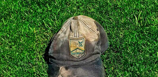 old cricket cap on grass
